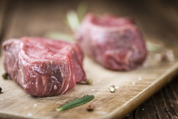 Old wooden Table with raw Beef Fillet