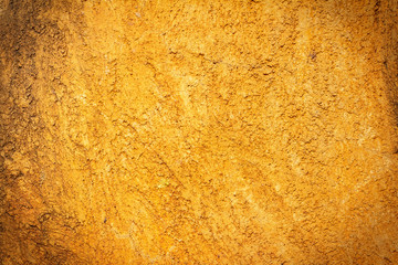Abstract background texture cement wall in  orange yellow tone.