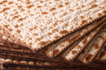 Pile of Jewish Matza Flatbread texture close-up, horizontal 
