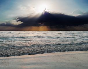 Sea and beach storm with sun ray