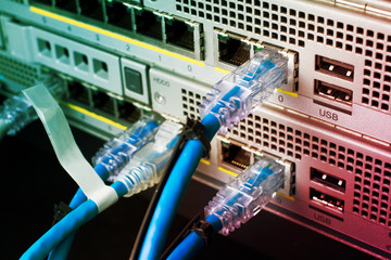 Closeup network cables connected to switches server computer.