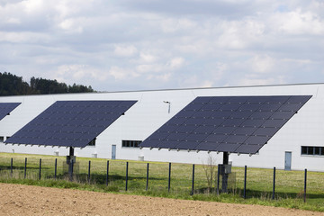 Solar Power Station on the spring flowering Meadow in the sunny Day