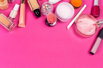 Set of colorful cosmetics on pink table