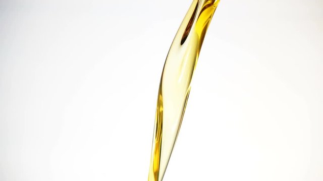 Motor oil pouring on white background. 
