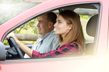 Young woman takes driving lesson