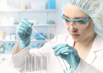 Young female tech or scientist performs protein assay
