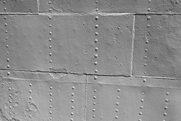 Old gray metal wall with rivets, vintage ship hull