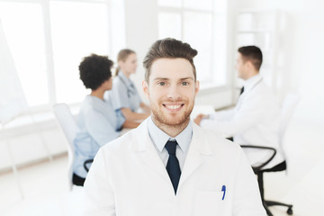Fototapeta premium happy doctor over group of medics at hospital