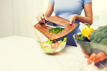 close up of woman with chopped onion cooking salad