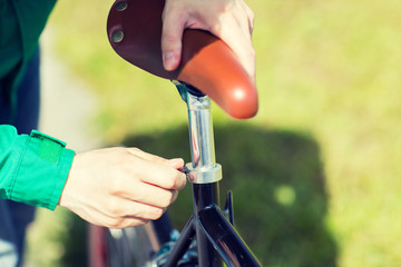 close up of man adjusting fixed gear bike saddle
