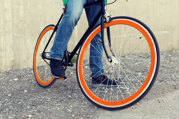 close up of man on fixed gear bike on city street