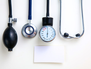 Silver stethoscope lying down on an laptop, toned blue