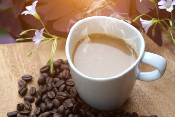 Coffee and beans on a wood background.