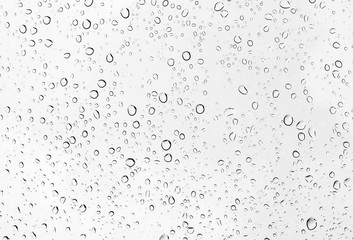 Fototapeta na wymiar Water drops or raindrop on glass of car.