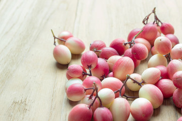 carunda fruit on wooden background