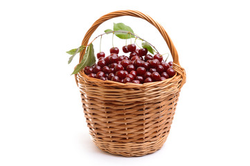 Basket full of fresh red cherry on a white background