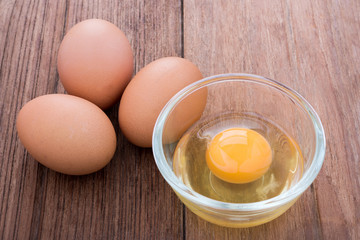 chicken egg in the glass bowl on the wooden table