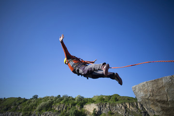 Jump off a cliff with a rope.