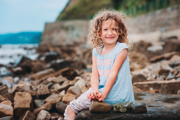 happy child girl playing on the beach
