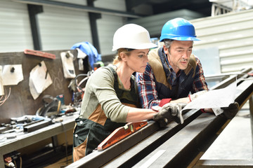 Engineers working in metallurgy warehouse