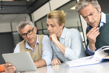 Business people in a meeting using tablet