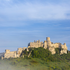 Fototapeta na wymiar old walls of castle under morning blue sky