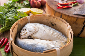 steamed mackerel in  bamboo basket, ready for cooking in Asian kitchen