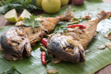 fried mackerel with asian heab on the banana leaf. Cooking  in Asian kitchen. Spicy meal.