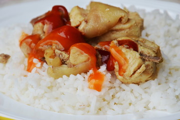 fried salty chicken dressing ketchup and chili sauce on plain rice