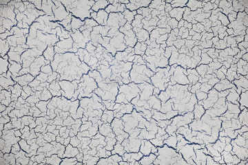 Grey cracked plaster wall background