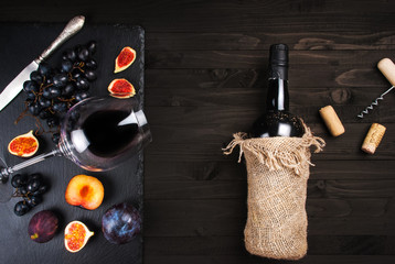 Food background with red wine, figs, grapes