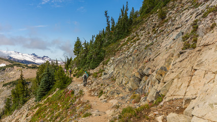 Rocky slopes in the mountains. Amazing view at the peaks which rose against the cloud sky. Path on the tops of mountains. MOUNT FREMONT LOOKOUT TRAIL, Sunrise Area, Mount Rainier