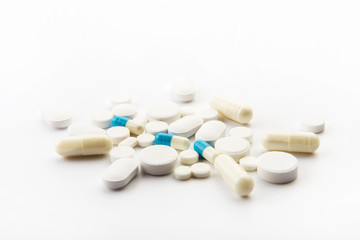 Different colored tablets on a white background close