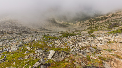 Rocky slopes in the mountains. Amazing view at the peaks which rose against the cloud sky. MOUNT FREMONT LOOKOUT TRAIL, Sunrise Area, Mount Rainier