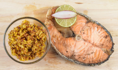 Salmon steaks,Turmeric rice in glass bowl on wooden Cutting Boar