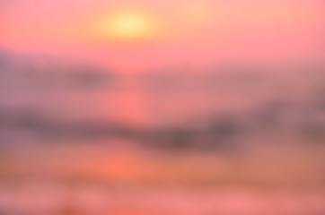 Blur tropical sunset beach with bokeh sun light wave abstract background. Travel concept.