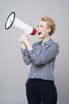 Businesswoman in the studio using megaphone