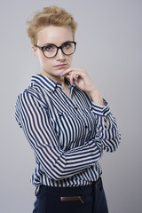 Serious businesswoman on gray background