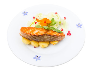 Grilled salmon fillet with sliced cucumbers.