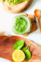 Fototapeta na wymiar green detox smoothie with spinach, kiwi and citrus, top view