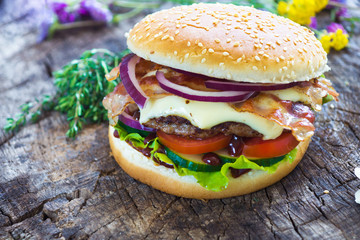 Homemade burgers on wooden background