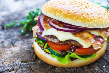 Homemade burgers on wooden background