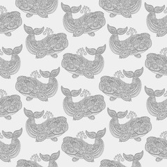 Naklejka premium Whale in paisley doodle mehndi style. Hand drawn illustration with whale. Wallpaper seamless textile pattern. Animal in the sea and ocean.