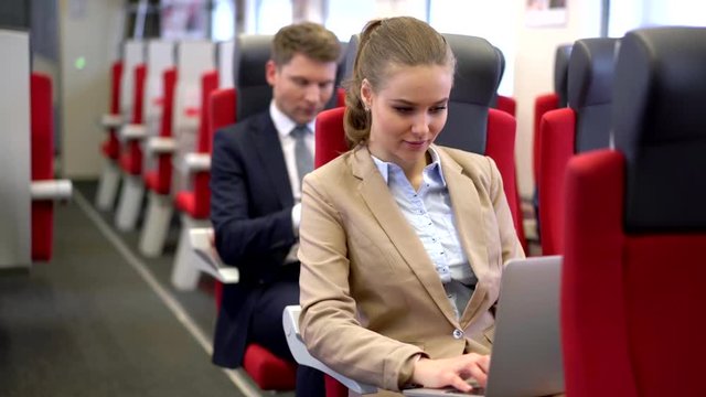 Businesswoman with laptop on a train