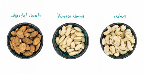 Unblanched almonds, blanched almonds and cashews in bowls, on white background