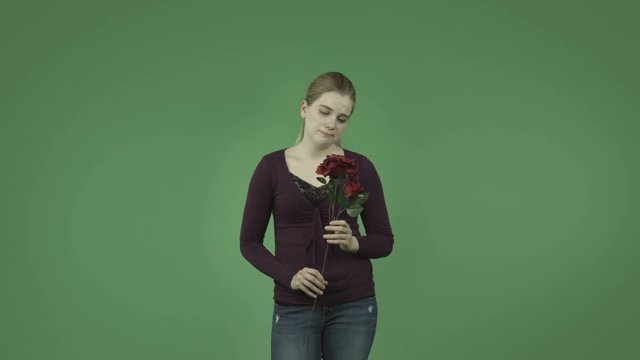 attractive casual caucasian girl isolated on green depressed love with roses