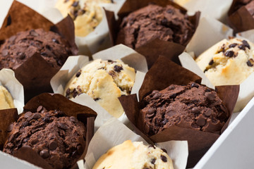 Chocolate and vanilla muffins, paper cupcake holder, cupcake box, selective focus, close up