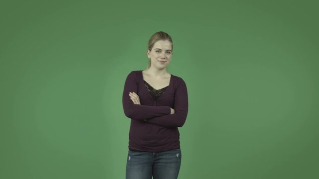 attractive casual caucasian girl isolated on green confident smiling