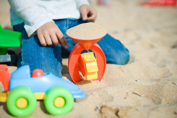 Child playing with beach sand toys