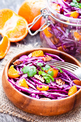 healthy  fresh salad with red cabbage and oranges with walnuts i